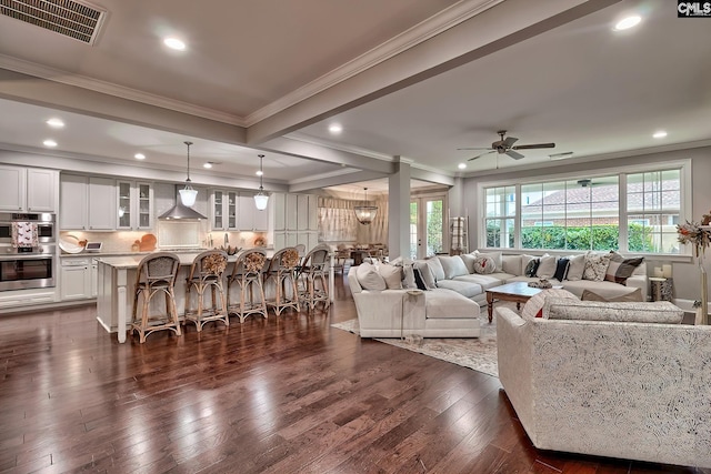 living room featuring ceiling fan, dark wood-type flooring, and ornamental molding