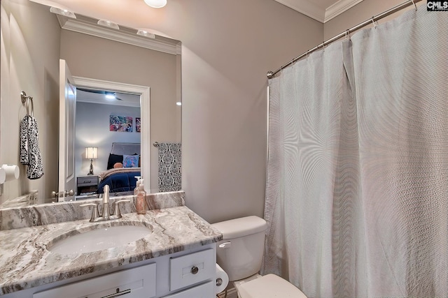 bathroom featuring vanity, toilet, and ornamental molding