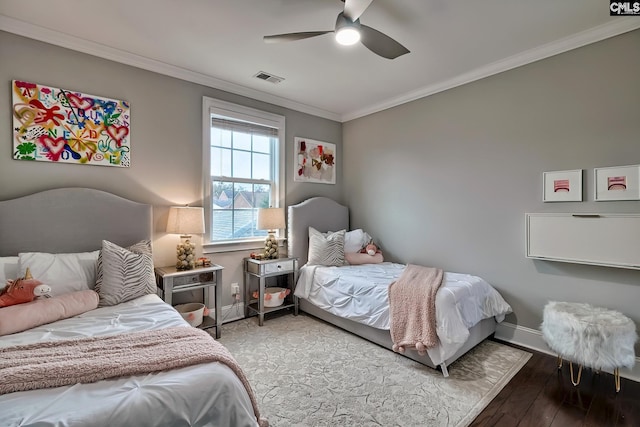 bedroom with ceiling fan, crown molding, and wood-type flooring