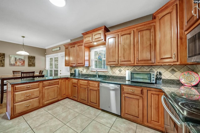 kitchen featuring pendant lighting, crown molding, sink, light tile patterned floors, and appliances with stainless steel finishes