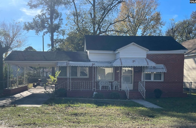 view of front of house featuring a front yard, a porch, and a carport