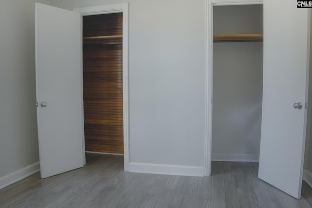 unfurnished bedroom featuring light hardwood / wood-style floors and a closet