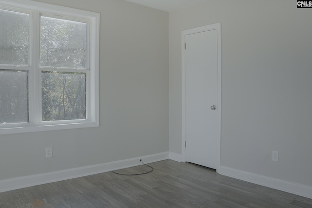 unfurnished room featuring hardwood / wood-style floors and a healthy amount of sunlight