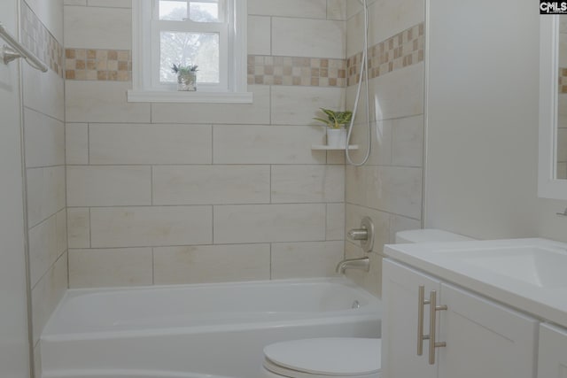 full bathroom with vanity, tiled shower / bath combo, and toilet