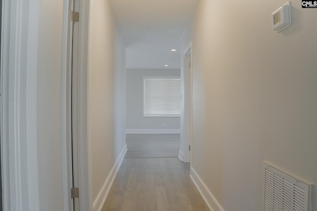 corridor with light hardwood / wood-style floors