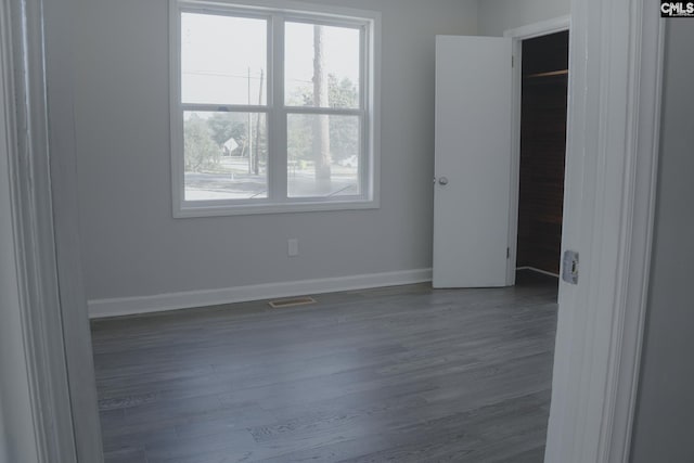 empty room with dark wood-type flooring