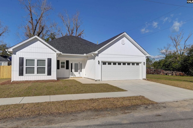 view of front of property with a front lawn and a garage