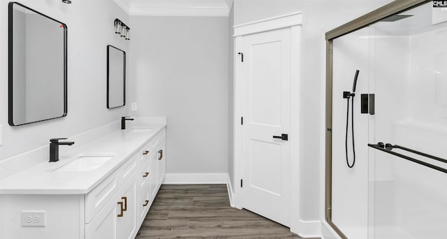 bathroom featuring walk in shower, ornamental molding, vanity, and hardwood / wood-style flooring