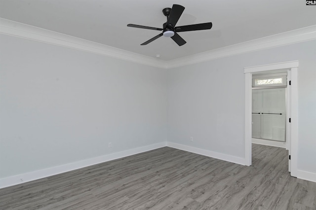 empty room with crown molding, ceiling fan, and hardwood / wood-style flooring