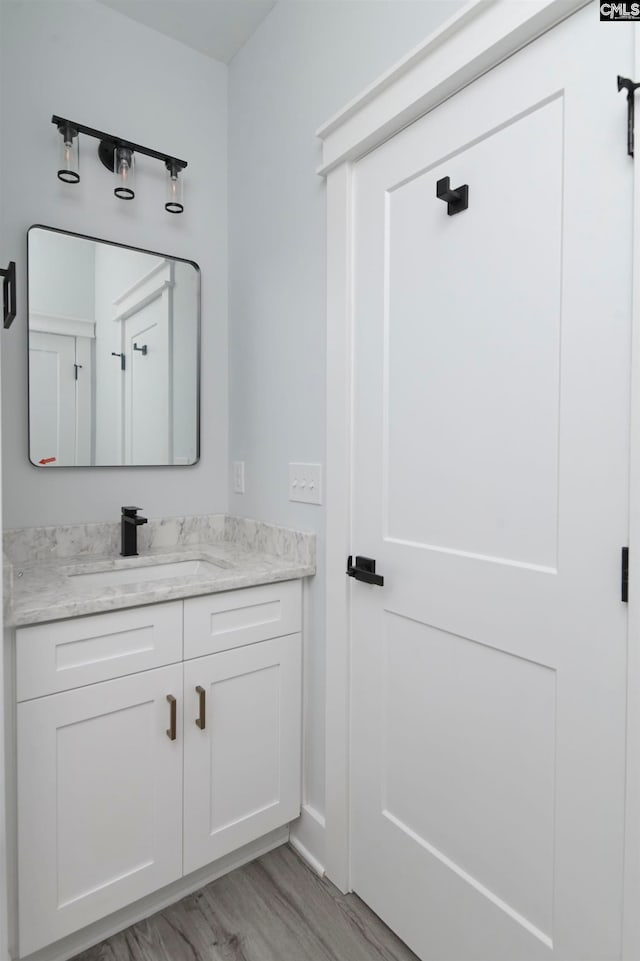 bathroom featuring wood-type flooring and vanity