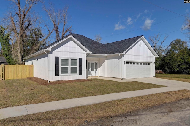 view of front of property with a garage and a front yard