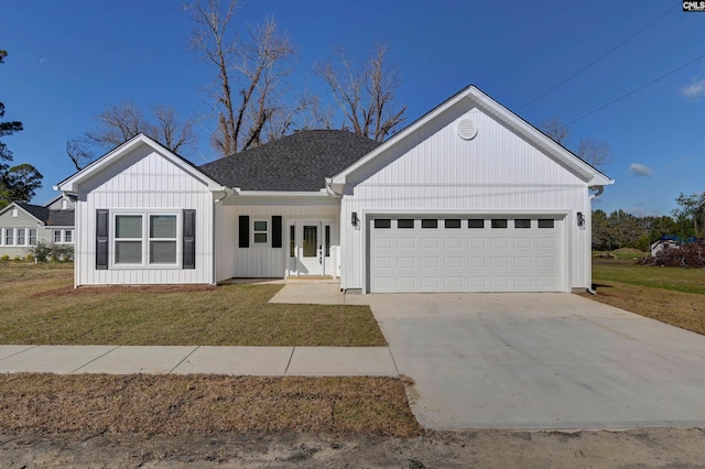 single story home featuring a garage and a front lawn