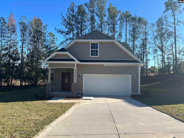 view of front of home with a garage and a front lawn