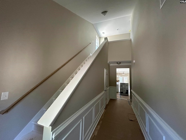 hall featuring dark colored carpet and vaulted ceiling