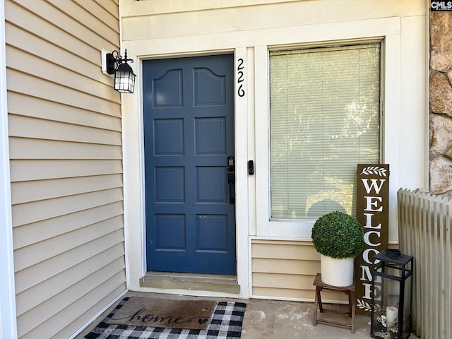 property entrance featuring radiator heating unit