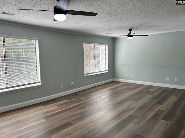 empty room with dark hardwood / wood-style floors, ceiling fan, a textured ceiling, and a wealth of natural light