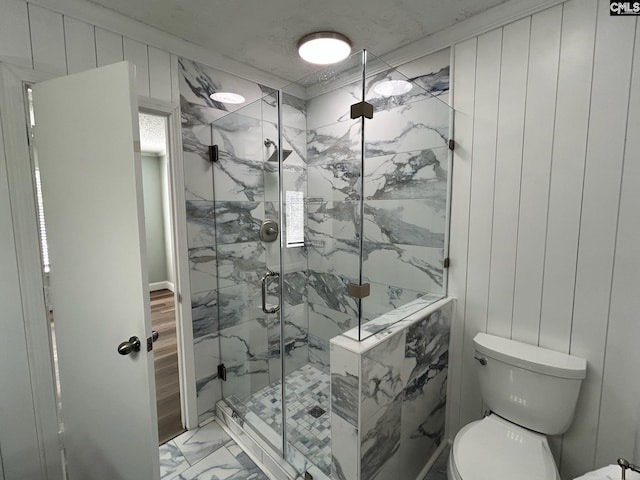 bathroom with crown molding, a shower with door, wooden walls, and toilet