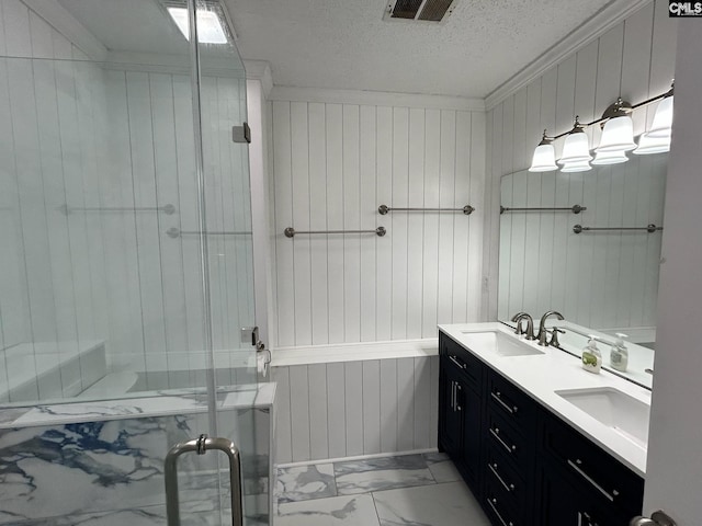 bathroom featuring crown molding, vanity, a shower with shower door, and a textured ceiling