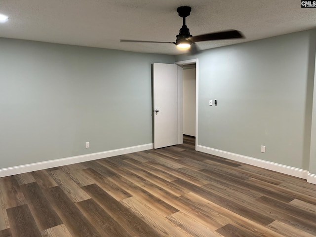 spare room with a textured ceiling, dark hardwood / wood-style floors, and ceiling fan