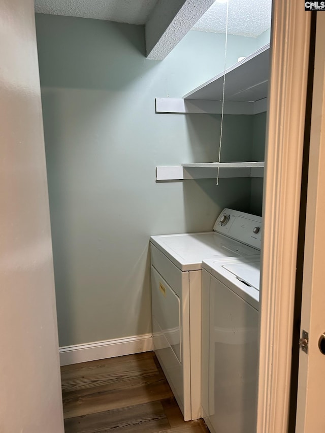 washroom featuring hardwood / wood-style floors, a textured ceiling, and separate washer and dryer