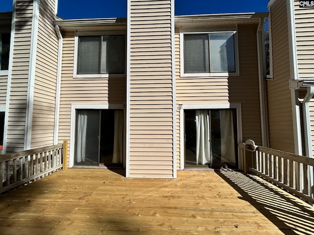 rear view of property featuring a deck