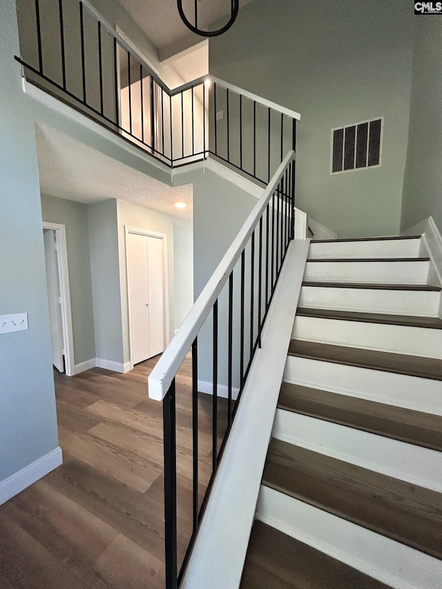 staircase featuring wood-type flooring