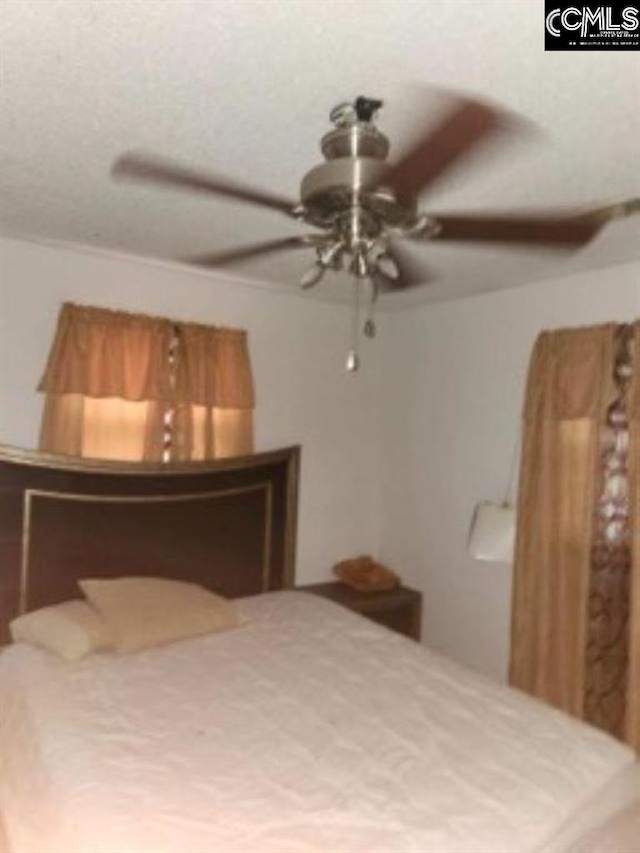 unfurnished bedroom with a textured ceiling and ceiling fan