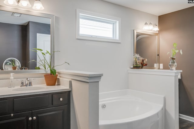 bathroom featuring vanity and a tub