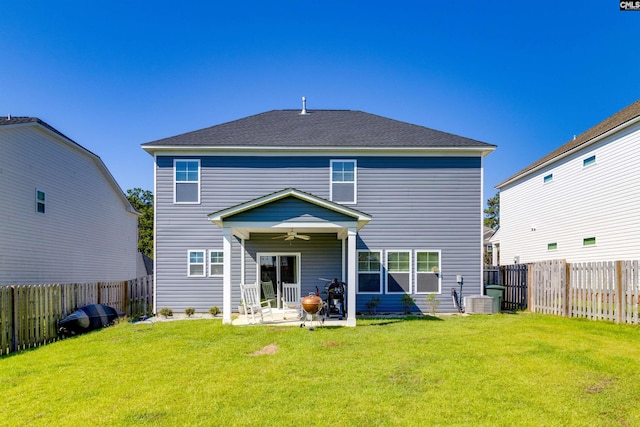 rear view of property with a patio, central AC, ceiling fan, and a lawn