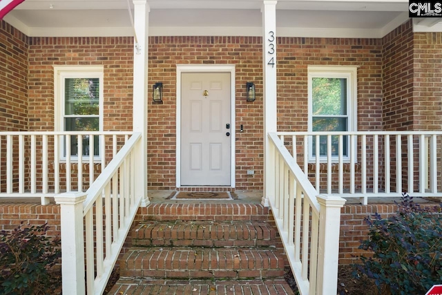 entrance to property featuring a porch