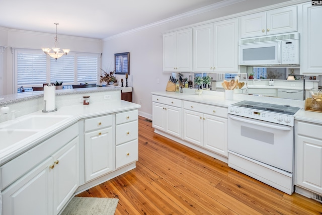 kitchen featuring white cabinetry, crown molding, decorative light fixtures, light wood-type flooring, and white appliances