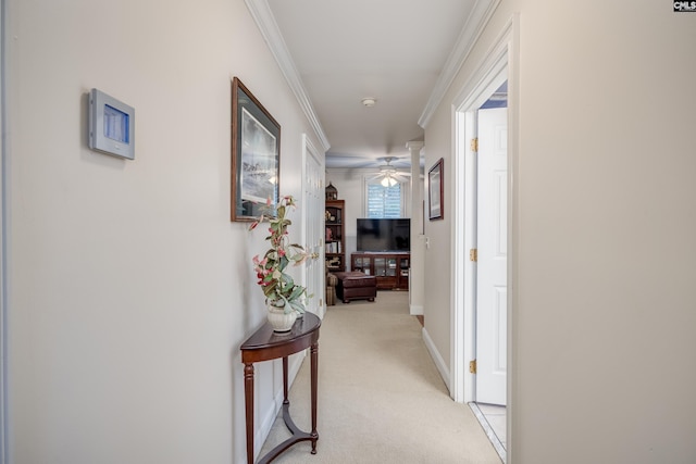 hallway featuring crown molding and light colored carpet