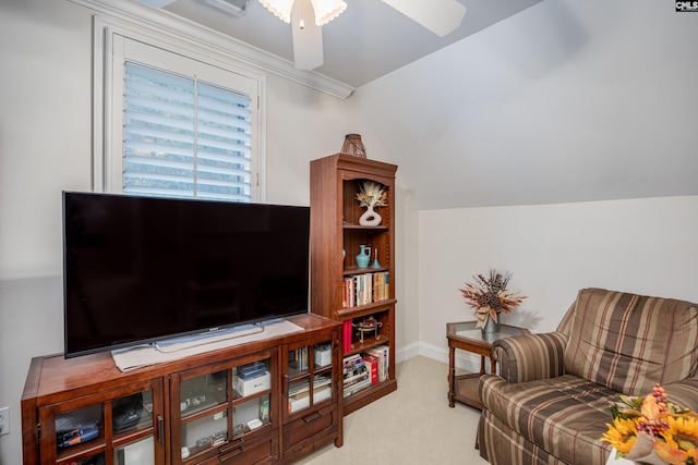 living area with light carpet, lofted ceiling, and ceiling fan