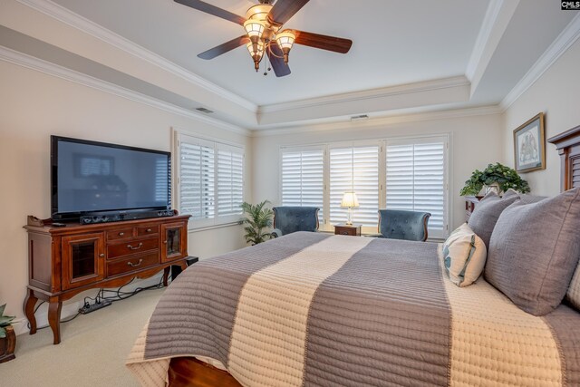 bedroom featuring crown molding, light colored carpet, a tray ceiling, and ceiling fan