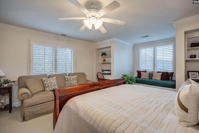 carpeted bedroom featuring crown molding and ceiling fan