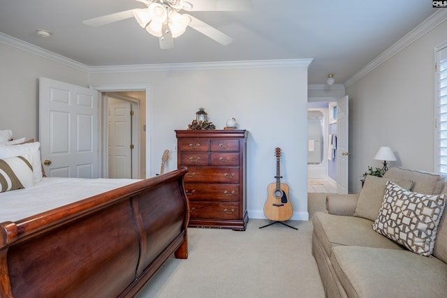 carpeted bedroom featuring ornamental molding, ceiling fan, and ensuite bath