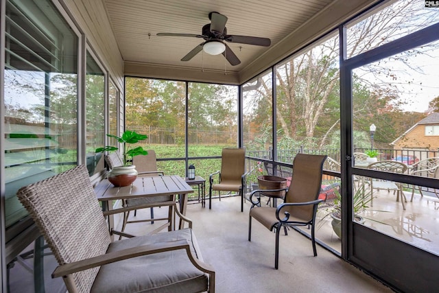 sunroom featuring ceiling fan