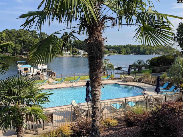 view of swimming pool with a patio and a water view