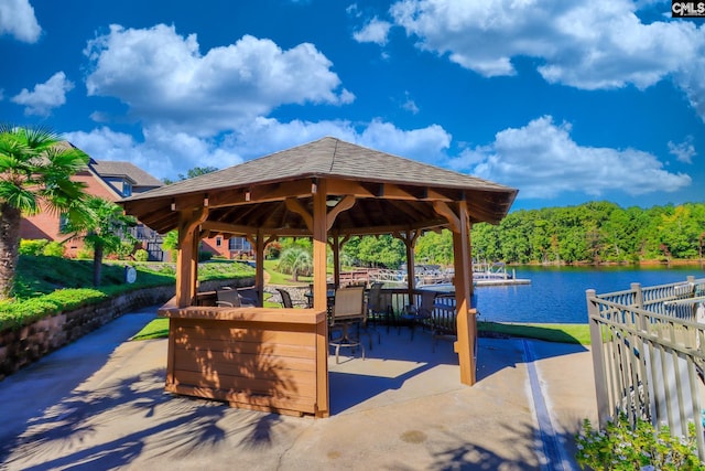 view of patio featuring a gazebo, a water view, and an outdoor bar