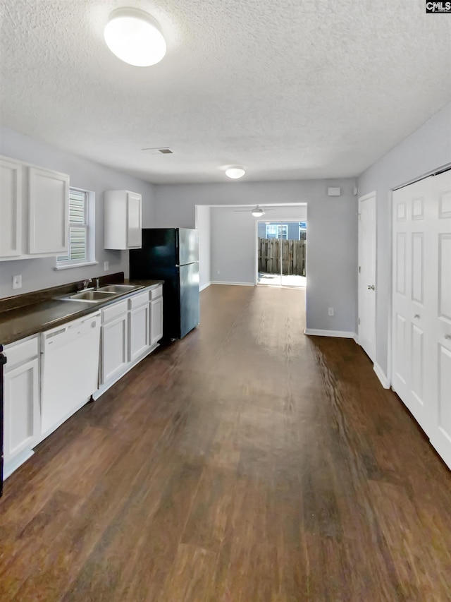 kitchen featuring dishwasher, dark hardwood / wood-style floors, black refrigerator, and white cabinetry