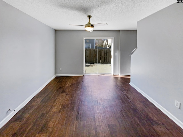 spare room with ceiling fan, dark hardwood / wood-style flooring, and a textured ceiling