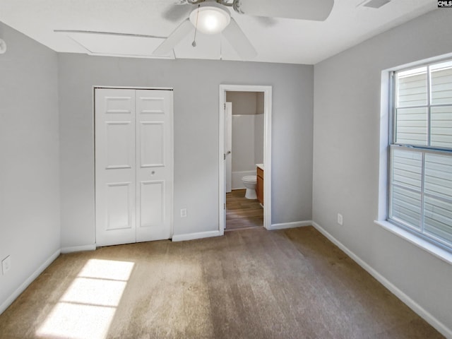 unfurnished bedroom with a closet, ceiling fan, hardwood / wood-style floors, and ensuite bathroom