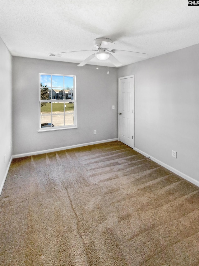 unfurnished room with carpet flooring, a textured ceiling, and ceiling fan