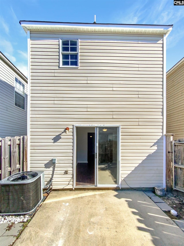 rear view of property featuring central air condition unit and a patio area