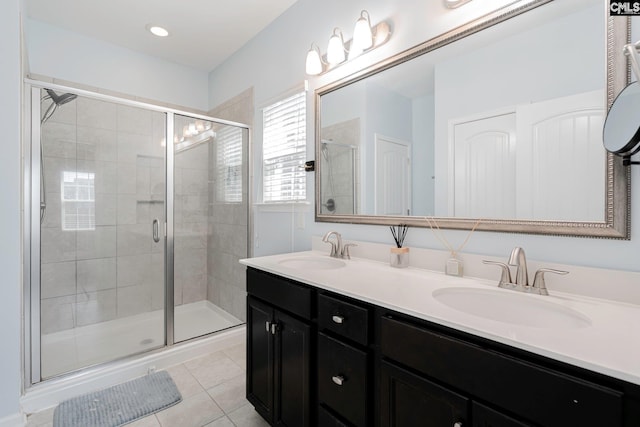 bathroom with tile patterned floors, vanity, and a shower with shower door