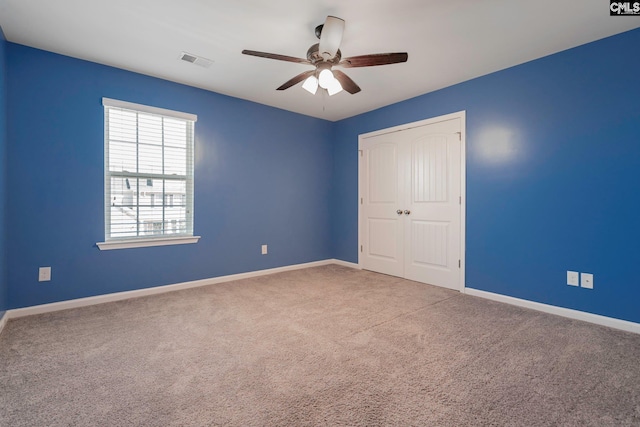 unfurnished bedroom featuring carpet flooring, a closet, and ceiling fan