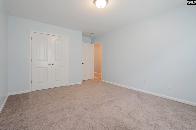 unfurnished bedroom with carpet floors and a closet