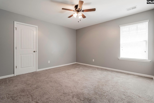 carpeted spare room with ceiling fan and a healthy amount of sunlight