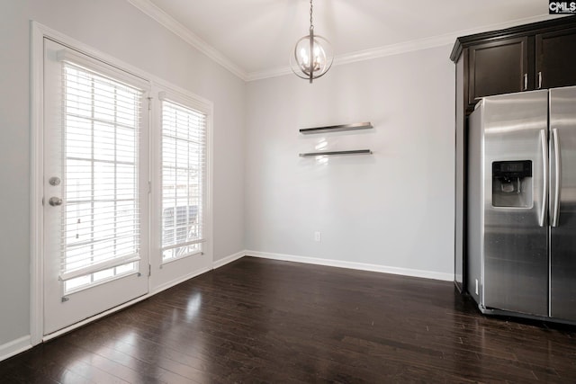 unfurnished dining area featuring dark hardwood / wood-style flooring, a chandelier, and ornamental molding