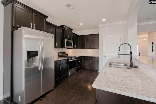 kitchen featuring sink, stainless steel appliances, dark hardwood / wood-style floors, crown molding, and decorative backsplash